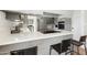 Modern kitchen boasts gray cabinets, stainless steel appliances, and a breakfast bar with seating at 4129 W Caron St, Phoenix, AZ 85051