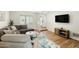 Comfortable living room with hardwood floors, neutral walls, and a cozy sectional sofa at 4129 W Caron St, Phoenix, AZ 85051