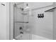 Updated shower with clear glass door and tiled walls, built in shower caddy and dual shower heads at 4129 W Caron St, Phoenix, AZ 85051