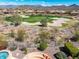 Aerial view showcasing a manicured golf course with sand traps surrounded by desert landscaping and mountain backdrop at 41819 N Anthem Ridge Dr, Phoenix, AZ 85086