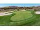 Aerial view of a lush green golf course with a sand trap and a flag at 41819 N Anthem Ridge Dr, Phoenix, AZ 85086