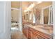 Bathroom features double vanity, light-toned walls, and tile flooring with a view to the connected bedroom at 41819 N Anthem Ridge Dr, Phoenix, AZ 85086