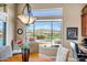 Bright dining area with a view of the backyard oasis, featuring a pool, spa, and beautiful desert landscape at 41819 N Anthem Ridge Dr, Phoenix, AZ 85086