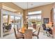 Dining area with large windows offering views of the pool and landscaping, adjacent to a built-in desk at 41819 N Anthem Ridge Dr, Phoenix, AZ 85086