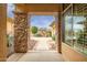 Inviting front porch with stone pillars welcomes you to a beautifully landscaped yard with desert plants and hardscape at 41819 N Anthem Ridge Dr, Phoenix, AZ 85086