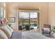 Bedroom offering views through sliding doors out to a pool with waterfall feature and mountains at 41819 N Anthem Ridge Dr, Phoenix, AZ 85086