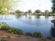 Scenic pond view with lush landscaping and a serene waterscape, perfect for relaxation and enjoying nature at 41819 N Anthem Ridge Dr, Phoenix, AZ 85086