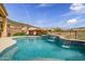 Inviting pool showcasing tranquil waterfalls surrounded by vibrant, mature landscaping and mountain views at 41819 N Anthem Ridge Dr, Phoenix, AZ 85086