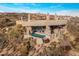 Stunning aerial view of a modern home with a pool nestled in a desert landscape at 41823 N 111Th Pl, Scottsdale, AZ 85262