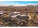 Stunning aerial view of custom home in a desert landscape with mountain views, under clear blue skies at 41823 N 111Th Pl, Scottsdale, AZ 85262