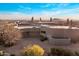 An aerial view of a desert home surrounded by beautiful landscaping and scenic mountains at 41823 N 111Th Pl, Scottsdale, AZ 85262