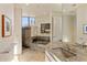 Elegant bathroom with granite counters, a sunken tub, a glass enclosed shower and views to the outdoors at 41823 N 111Th Pl, Scottsdale, AZ 85262