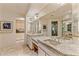 Spacious bathroom with double vanity, granite countertops, and large mirrors reflecting the space at 41823 N 111Th Pl, Scottsdale, AZ 85262