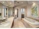 Bathroom featuring a soaking tub, dual vanities, and lots of natural light at 41823 N 111Th Pl, Scottsdale, AZ 85262