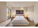 Bright bedroom featuring a comfortable bed, bedside tables, and natural light from the window at 41823 N 111Th Pl, Scottsdale, AZ 85262