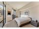 Bedroom featuring large windows, built-in storage and entertainment center, and neutral colored carpet at 41823 N 111Th Pl, Scottsdale, AZ 85262