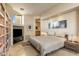 Beautiful bedroom with a king-sized bed, a large built-in bookcase, and modern artwork above the bed at 41823 N 111Th Pl, Scottsdale, AZ 85262