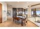 Sunlit dining room with modern table set, floor-to-ceiling windows, and seamless indoor-outdoor transition at 41823 N 111Th Pl, Scottsdale, AZ 85262