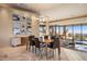 Dining room with pendant lighting, modern decor, and large windows offering panoramic views and stylish furniture at 41823 N 111Th Pl, Scottsdale, AZ 85262