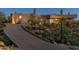 Stunning home exterior with a long driveway and landscaped with desert vegetation at 41823 N 111Th Pl, Scottsdale, AZ 85262