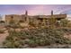 A desert home exterior amidst native desert landscaping, ensuring privacy at 41823 N 111Th Pl, Scottsdale, AZ 85262