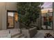 Inviting front entrance with stone steps, a wrought iron gate, and a mature tree at 41823 N 111Th Pl, Scottsdale, AZ 85262