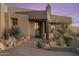 Inviting front entrance with desert landscaping, featuring rocks, cacti, and native plants at 41823 N 111Th Pl, Scottsdale, AZ 85262