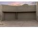 Wide two car garage with neutral tone doors and a paved driveway at 41823 N 111Th Pl, Scottsdale, AZ 85262