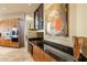 Gourmet kitchen featuring granite countertops, custom cabinetry, built-in appliances, and adjacent dining area at 41823 N 111Th Pl, Scottsdale, AZ 85262
