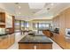 Bright kitchen with granite countertops, wooden cabinetry, and stainless steel appliances with a large island at 41823 N 111Th Pl, Scottsdale, AZ 85262