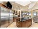 Gourmet kitchen featuring stainless steel appliances, spacious island, and floor-to-ceiling cabinetry with natural light at 41823 N 111Th Pl, Scottsdale, AZ 85262