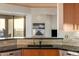Kitchen sink with tile backsplash, ample lighting, and scenic views, perfect for gourmet cooking at 41823 N 111Th Pl, Scottsdale, AZ 85262