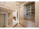 Well lit kitchen featuring granite countertops and sleek cabinetry with glass door accents at 41823 N 111Th Pl, Scottsdale, AZ 85262