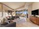 Spacious living room with modern leather seating, fireplace, and expansive window views at 41823 N 111Th Pl, Scottsdale, AZ 85262