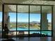 Bright living room with floor-to-ceiling windows offering views of the pool and mountains at 41823 N 111Th Pl, Scottsdale, AZ 85262