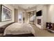 Main bedroom features a fireplace, access to a balcony, and a luxurious feel at 41823 N 111Th Pl, Scottsdale, AZ 85262