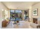 Bright office space with large windows, fireplace, and desert landscaping views at 41823 N 111Th Pl, Scottsdale, AZ 85262