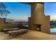 A relaxing patio with lounge chairs, fireplace, and stunning sunset views at 41823 N 111Th Pl, Scottsdale, AZ 85262