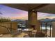 An outdoor patio with chairs, fireplace, mountain views, and an inviting atmosphere at 41823 N 111Th Pl, Scottsdale, AZ 85262