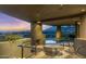 Outdoor patio area with fireplace and mountain views, perfect for relaxing evenings at 41823 N 111Th Pl, Scottsdale, AZ 85262