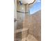 Elegant walk-in shower with granite tile, a built-in bench, designer trim, and a window at 41823 N 111Th Pl, Scottsdale, AZ 85262