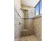 Elegant walk-in shower with granite tile, a built-in bench, designer trim, and a window at 41823 N 111Th Pl, Scottsdale, AZ 85262