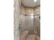 Well designed shower with granite surround, built-in seating, and modern fixtures at 41823 N 111Th Pl, Scottsdale, AZ 85262