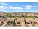 Aerial view of the house, neighborhood and surrounding area with mountain views at 42920 W Kingfisher Dr, Maricopa, AZ 85138