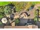 Aerial view of a backyard featuring a firepit, water feature, covered patio and lush landscaping at 42920 W Kingfisher Dr, Maricopa, AZ 85138