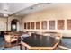 Charming card room with decorative card art, round tables, ceiling fan, and comfortable chairs, designed for gaming enthusiasts at 42920 W Kingfisher Dr, Maricopa, AZ 85138