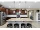 Lovely kitchen featuring a large island, stainless steel appliances, and dark wood cabinetry at 42920 W Kingfisher Dr, Maricopa, AZ 85138