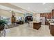 Bright open-concept living space with a kitchen island, tile floors, and a cozy seating area at 42920 W Kingfisher Dr, Maricopa, AZ 85138