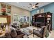 Cozy living room features plush seating, a built-in entertainment center, and bright natural light at 42920 W Kingfisher Dr, Maricopa, AZ 85138