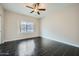 Bright, empty bedroom with tile floors and a window showcasing the neighborhood at 4465 E Paradise Village S Pkwy # 1133, Phoenix, AZ 85032